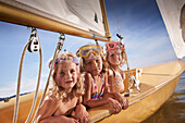 Three girls in a sailing boat on lake Starnberg, Upper Bavaria, Bavaria, Germany