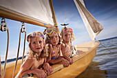 Three girls in a sailing boat on lake Starnberg, Upper Bavaria, Bavaria, Germany