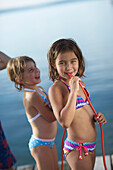 Two girls with fruitgum sticks, lake Starnberg, Upper Bavaria, Bavaria, Germany