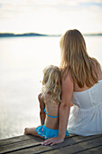 Mother and daughter on a jetty at lake Starnberg, Upper Bavaria, Bavaria, Germany