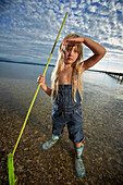 Girl with a dip net in lake Starnberg, Upper Bavaria, Bavaria, Germany
