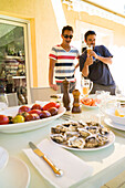 Men at a table, Perols, Montpellier, Herault, Languedoc-Roussillon, France