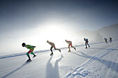 Ice speed skaters on lake Weissensee, Alternative Eleven cities tour, Weissensee, Carinthia, Austria