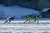 Ice speed skaters on lake Weissensee, Alternative Eleven cities tour, Weissensee, Carinthia, Austria