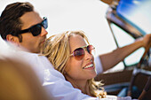 Young couple, sunglasses, convertible, happy