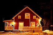 Wooden house decorated with Christmas lights