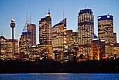 Sydney business district from ferry on harbour at dusk, Sydney, NSW, Australia