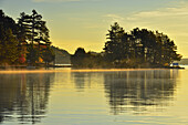 Reflections in Penage/Panache Lake at dawn near the Penage/Panache Lake marina, Greater Sudbury (Penage Lake area), Ontario, Canada.