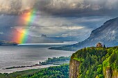 A view down the Columbia River gorge with a rainbow near sunset, Oregon, USA.