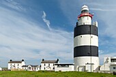 Hook Lighthouse, one of the oldest operational lighthouses in the world, marks the entrance to Waterford harbour at the mouth of the Three Sisters river system for over 800 years, Co. Wexford, Ireland