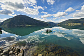 boat and sky reflection along Sognefjord, Norway.