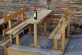 An empty table and an empty bottle of wine Siena Tuscany Italy