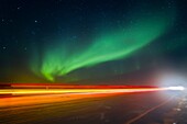 Aurora Borealis Northern Polar Lights with truckers lights on the ice road outside Yellowknife, Northwest Territories, Canada, MORE INFO The term aurora borealis was coined by Pierre Gassendi in 1621 from the Roman goddess of dawn, Aurora, and the Greek n