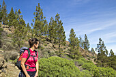 Female hiker in Pine forest near Roque Nublo on Gran Canaria, Canary Islands, Spain.
