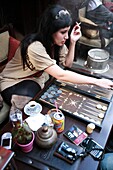 Attractive Turkish woman playing Backgammon at a Cafe, Ortakcoy district, Istanbul, Turkey