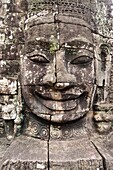 Stone face of Bayon temple (12th/13th Century). Angkor Thom. Angkor Archaeological Park, Siem Reap Province, Cambodia, Southeast Asia.