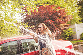 Young woman being sprayed with water