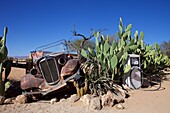 rusty old car and old gasoline pump in Solitaire, Namibia