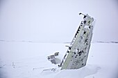 Parts of a crashed airplane in the snow-covered tundra, Chukotka Autonomous Okrug, Siberia, Russia