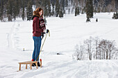 Young woman with a sled, Spitzingsee, Upper Bavaria, Germany