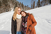 Two young women in snow, Spitzingsee, Upper Bavaria, Germany