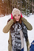 Young woman covering her ears, Spitzingsee, Upper Bavaria, Germany