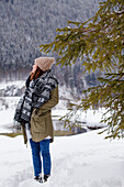 Young woman in snow near lake Spitzingsee, Upper Bavaria, Germany