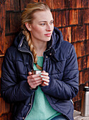 Young woman holding a mug, Spitzingsee, Upper Bavaria, Germany