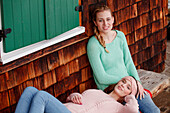 Two young women on a bench, Spitzingsee, Upper Bavaria, Germany