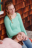 Two young women on a bench, Spitzingsee, Upper Bavaria, Germany