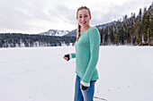 Young woman in snow, Spitzingsee, Upper Bavaria, Germany