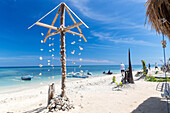 Wind chime of corals and shells at white sandy beach, Gili Air, Lombok, Indonesia