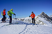 Several persons back-country skiing having a break, Hornspitze in background, Frauenwand, valley of Schmirn, Zillertal Alps, Tyrol, Austria