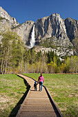 young woman with toddler, path on Merced River, Upper Yosemmite Falls, Yosemite National Park, California, USA