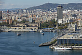 view across the harbour and town, Edificio Colon - Torre Maritima, architect Daniel Gelabert i Fontova, 1970, Maremagnum shopping centre, Port Vell, Barcelona, Catalunya, Catalonia, Spain, Europe