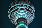 Colourfully illuminated TV tower Alex at night, Berlin Alexanderplatz, Berlin, Germany