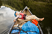 A girl on a canoe trip on the Whanganui River, North Island, New Zealand