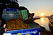 Fruit being loaded into a truck, at the Ferryboat at the river Mekong, Luang Prabang, Laos, Asia
