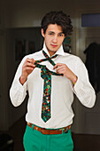 Young man getting dressed, Shirt and tie