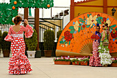 Three women in Flamenco dresses, Freia de Malaga, Malaga, Andalusia, Spain