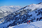 Two persons back-country skiing ascending towards Pallspitze, Pallspitze, Langer Grund, Kitzbuehel range, Tyrol, Austria