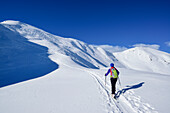 Woman back-country skiing asending towards Floch, Floch, valley of Spertental, Kitzbuehel range, Tyrol, Austria