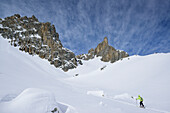 Woman back-country skiing ascending towards Colle d'Enchiausa, Valle Enchiausa, Valle Maira, Cottian Alps, Piedmont, Italy