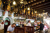 Pata Negras, Spanish ham speciality, hanging from the celing in the Bar Casa Balbino in Sanlucar de Barrameda, Cadiz province, Andalusia, Spain, Europe