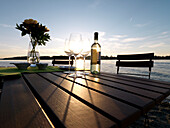 Bottle of wine and wine glasses at a table, Chiemsee, Bavaria, Germany