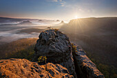 View from Gleitmannshorn over the small Zschand with fog at sunrise with rocks in the foreground, Little Winterberg, National Park Saxon Switzerland, Saxony, Germany