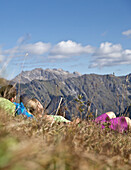 Couple having a break from hiking on a sunny day, Oberstdorf, Bavaria, Germany