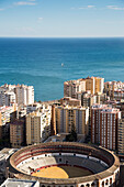 Overhead of Plaza de Toros bullfighting arena and high-rise apartment buildings, Malaga, Costa del Sol, Andalusia, Spain