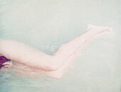 Woman in shallow water, cropped view of legs
