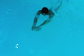 Man swimming, blurred